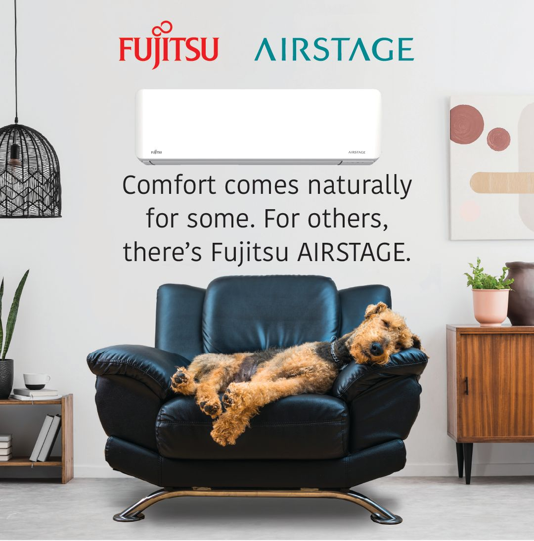 Fujitsu Airstage ad showing a dog lounging on a black sofa in a cozy living room.