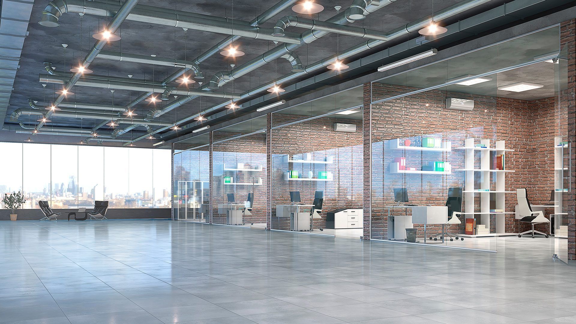 An empty office with a lot of windows and brick walls.