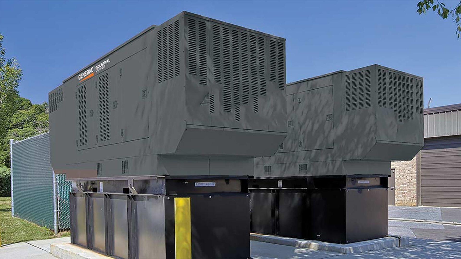 A large black container is sitting in front of a building