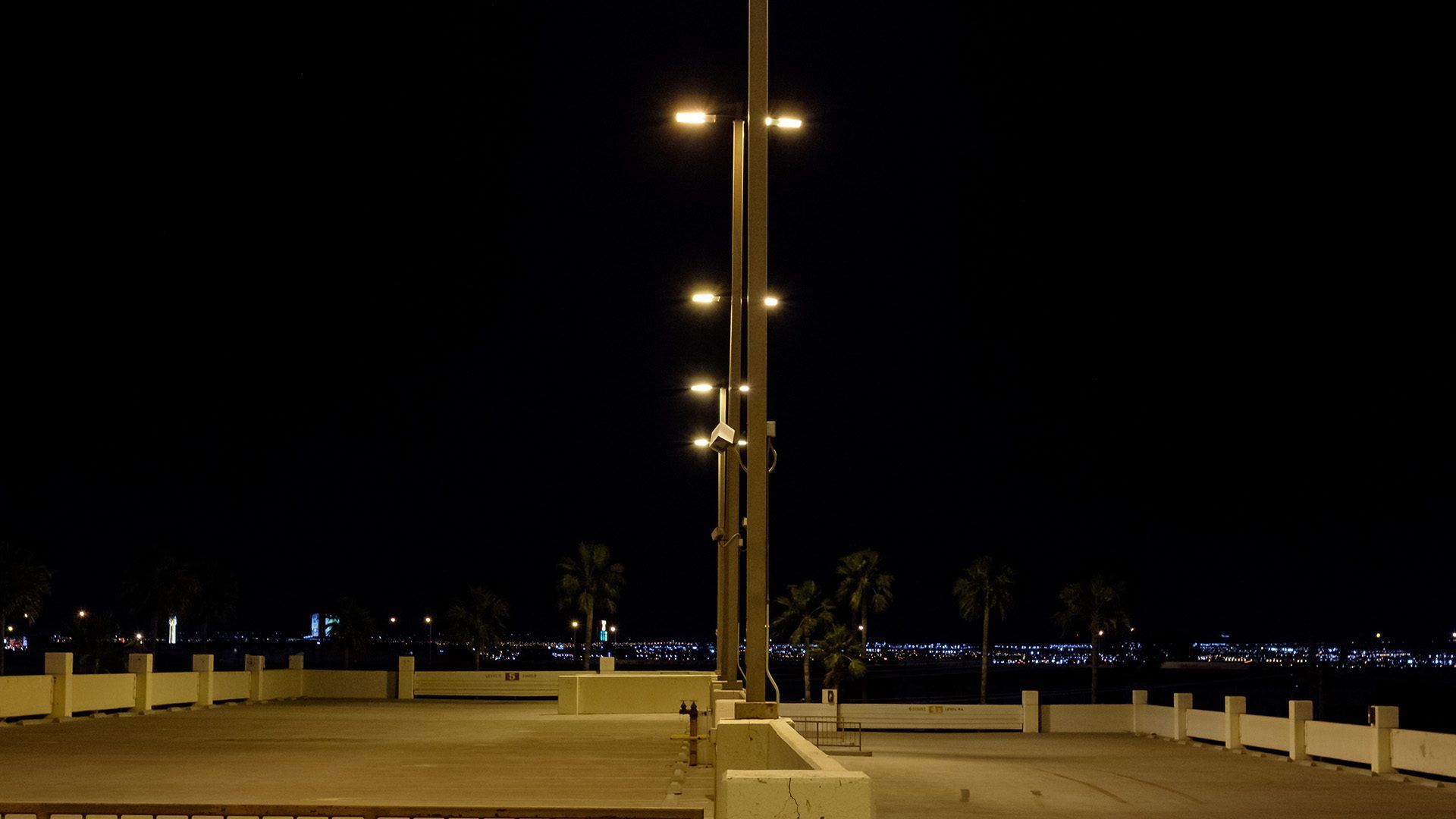 A parking lot with a lot of lights on at night.