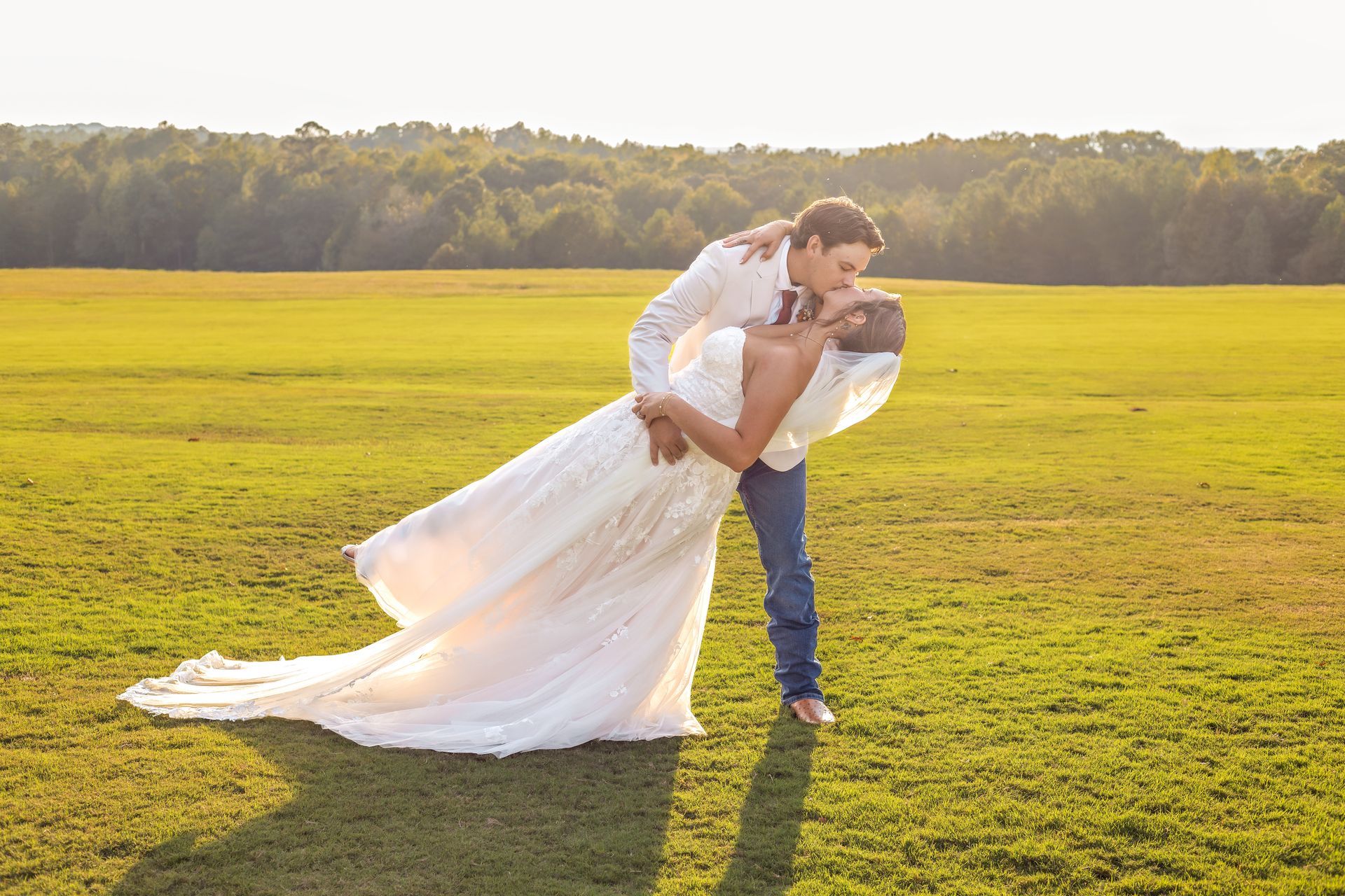 a couple kissing in a field