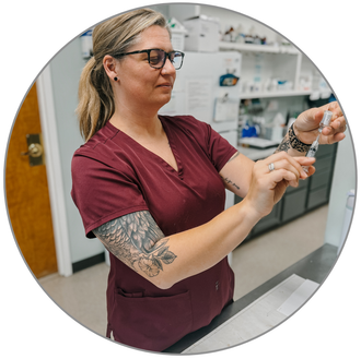 A woman drawing up vaccinations