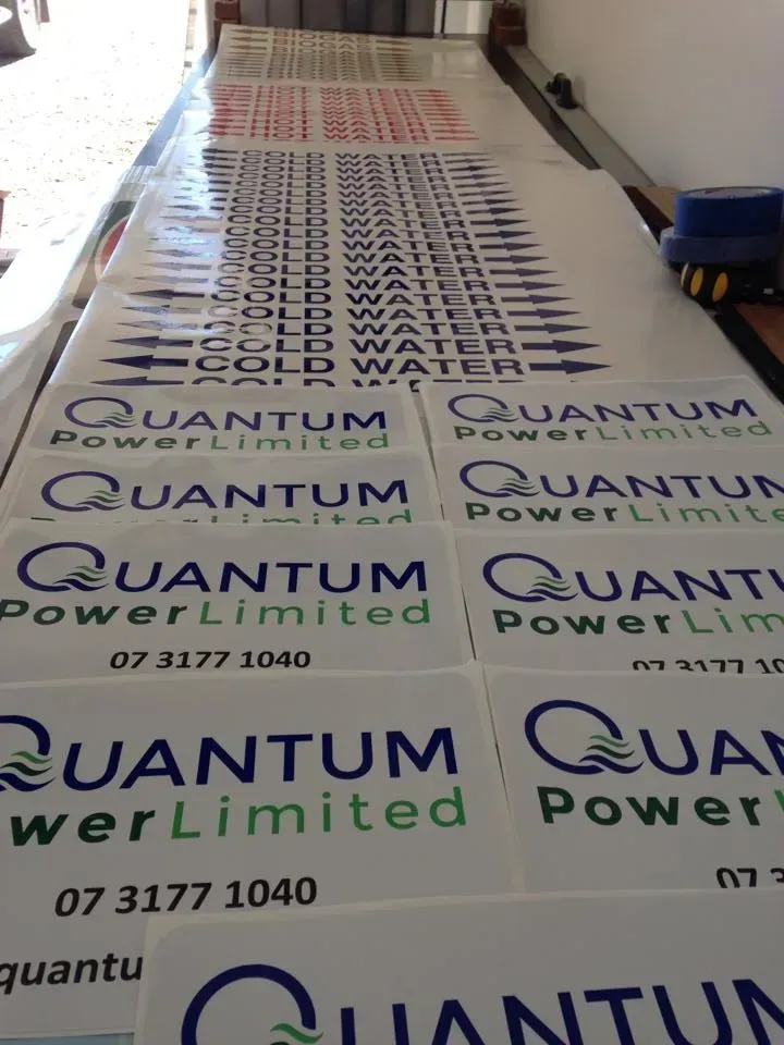 A bunch of quantum power limited stickers on a table
