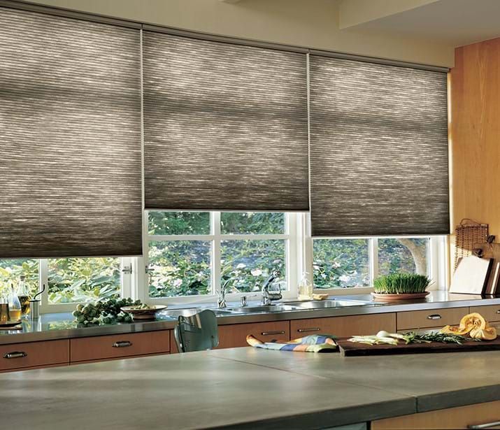 Kitchen with three closed, pleated blinds above a window, countertops, and a cutting board. Kitchen with three closed, pleated blinds above a window, countertops, and a cutting board.