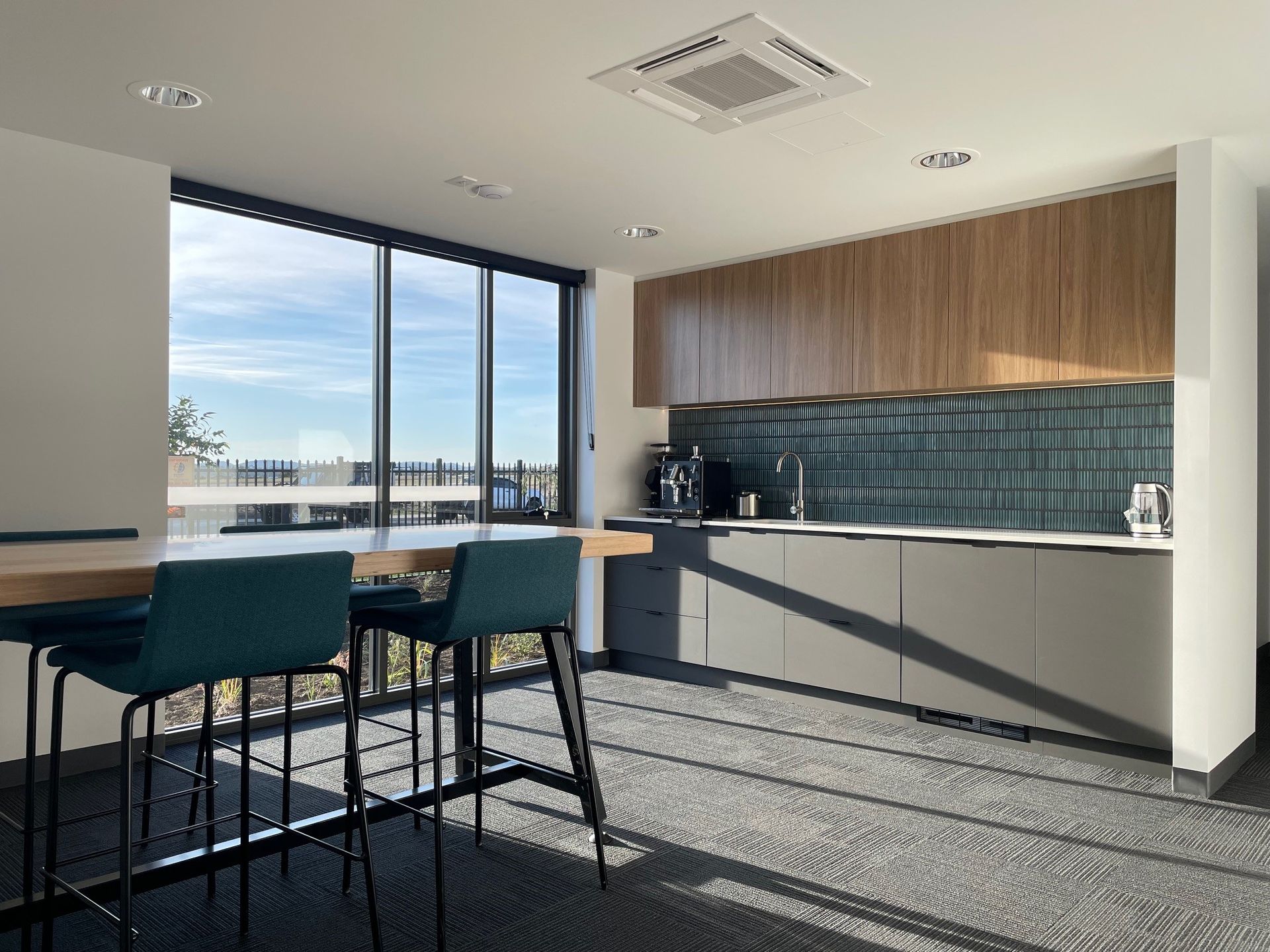 A Kitchen With A Table And Chairs And A Large Window – Cambridge, TAS - Bennett Construction (TAS)