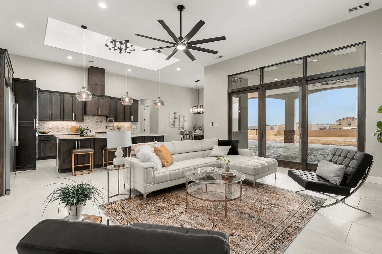 A living room filled with furniture and a ceiling fan.