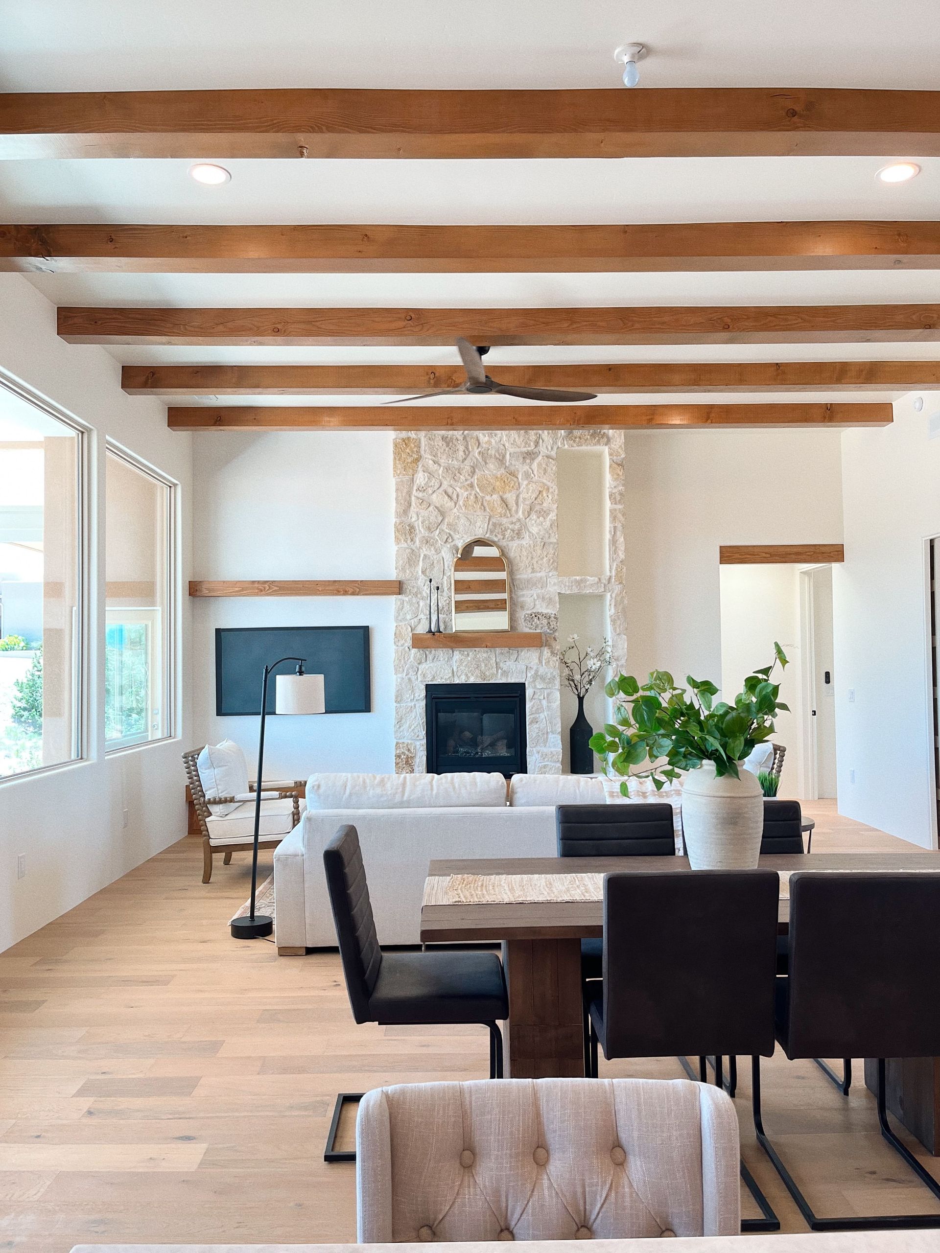 A living room with a fireplace and a table and chairs
