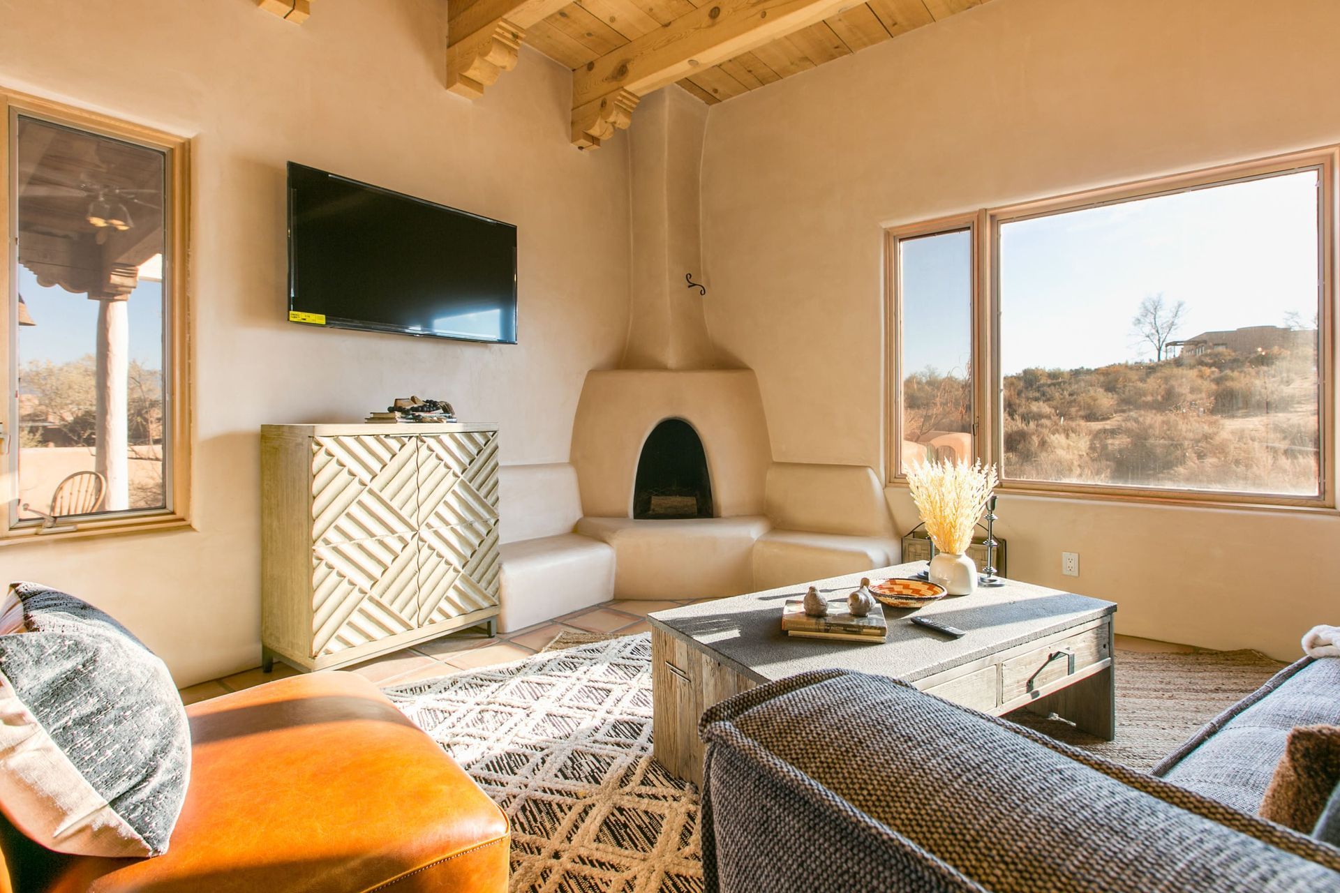 A living room with a fireplace and a flat screen tv.
