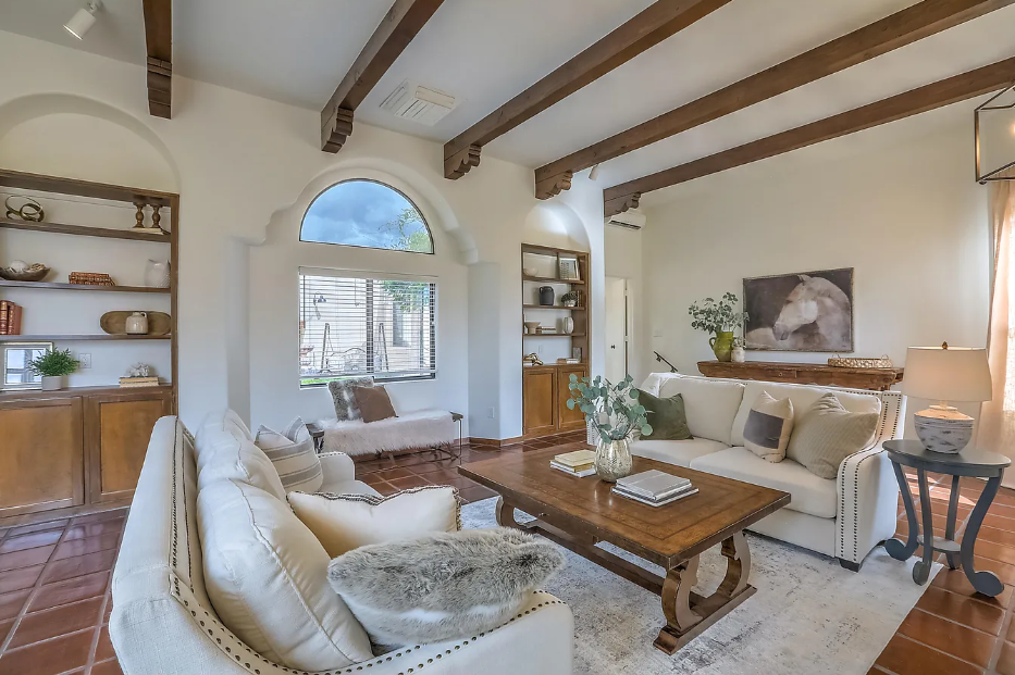 A living room with a couch , chair and coffee table.