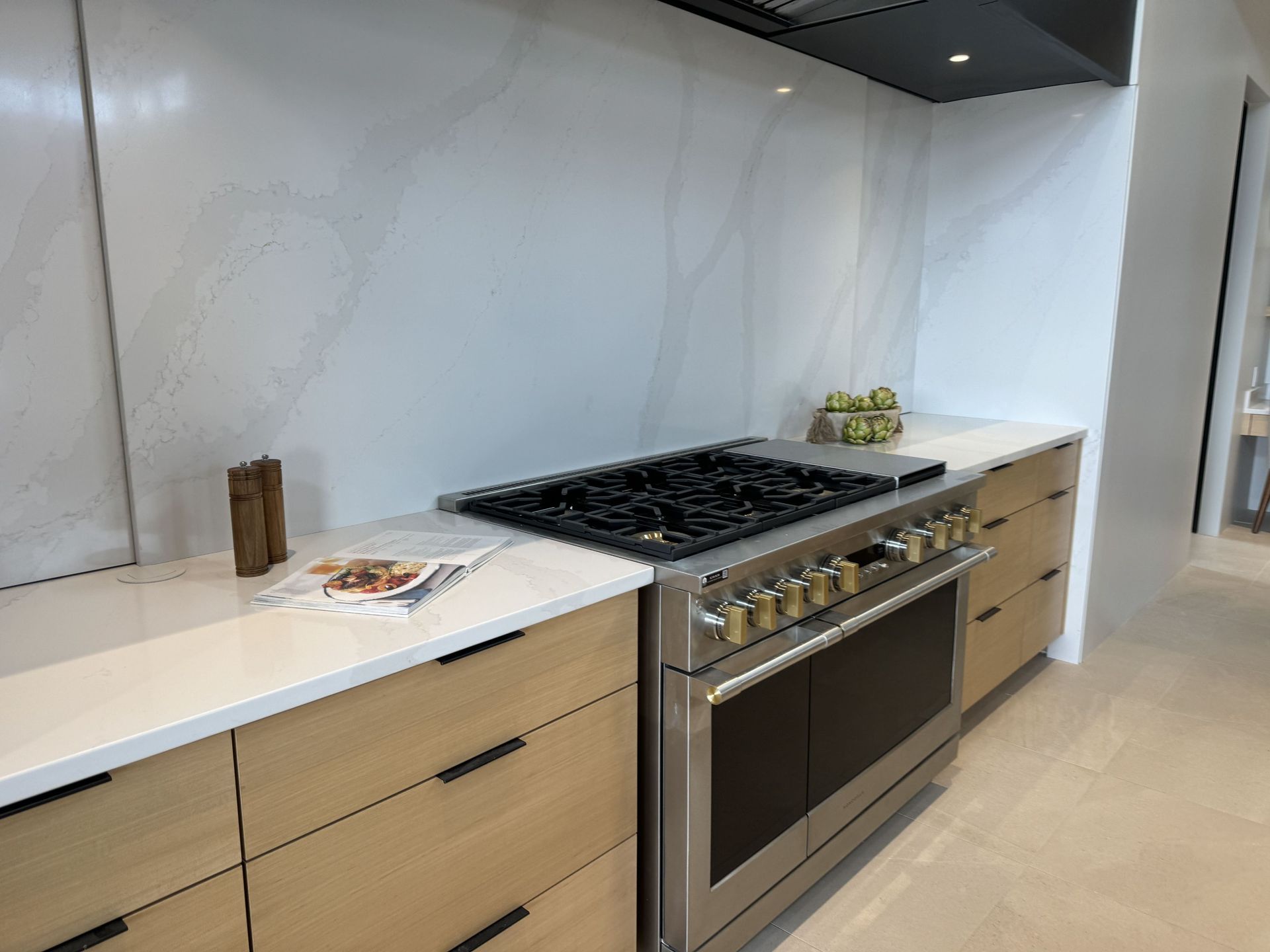 A kitchen with stainless steel appliances and wooden cabinets.