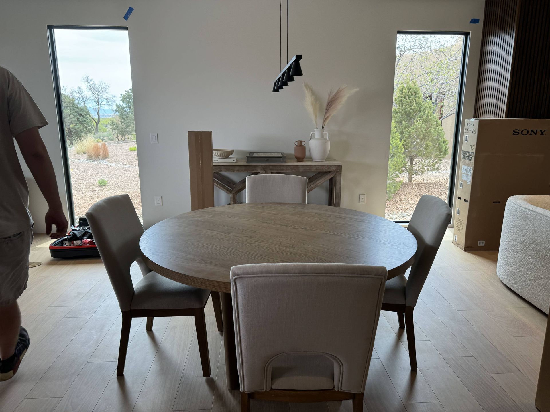 A dining room with a round table and chairs