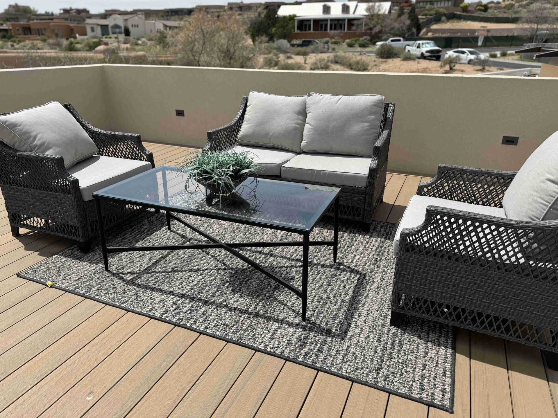 A patio with a couch , chairs and a coffee table