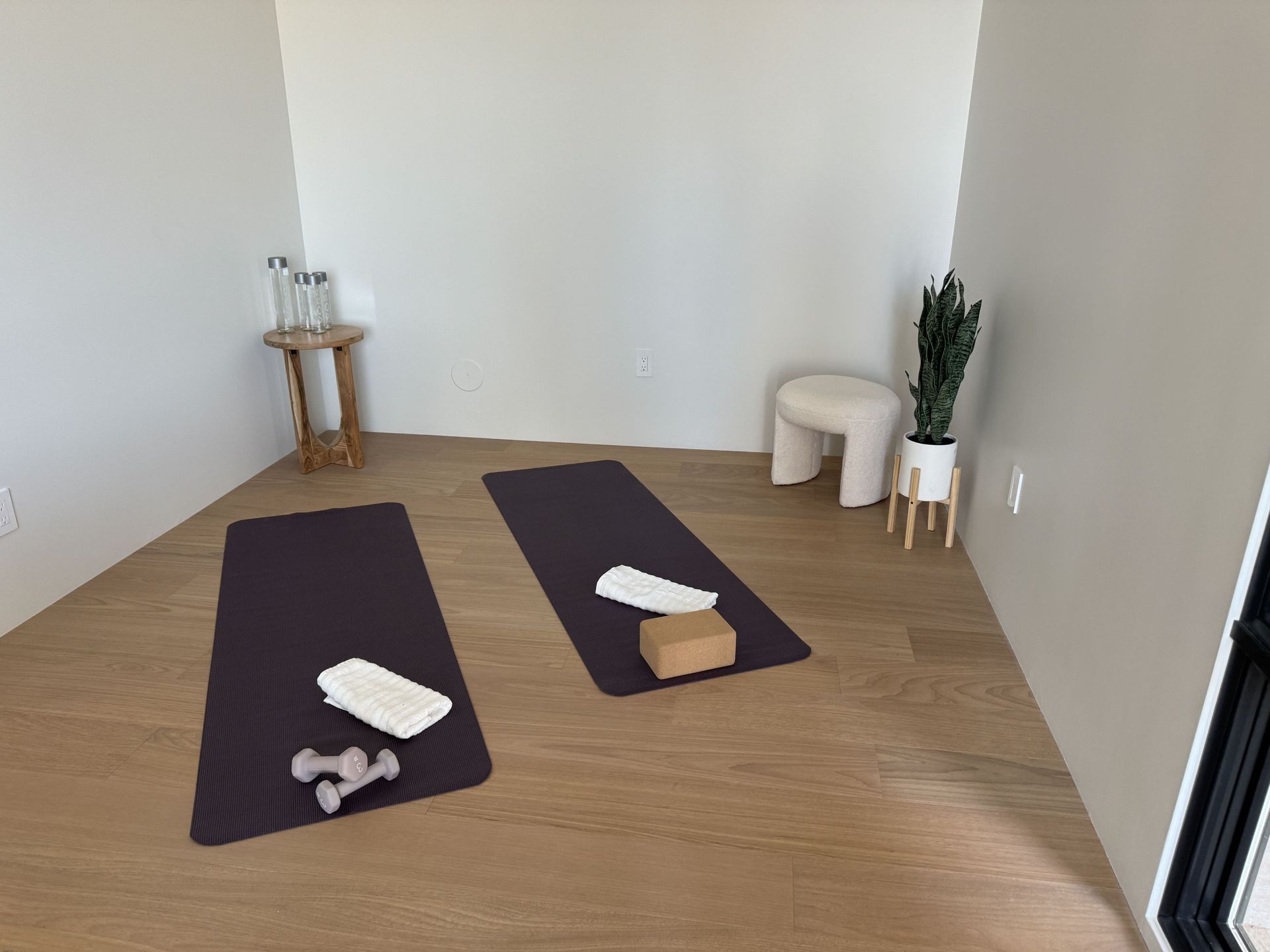 There are two yoga mats in the corner of the room.
