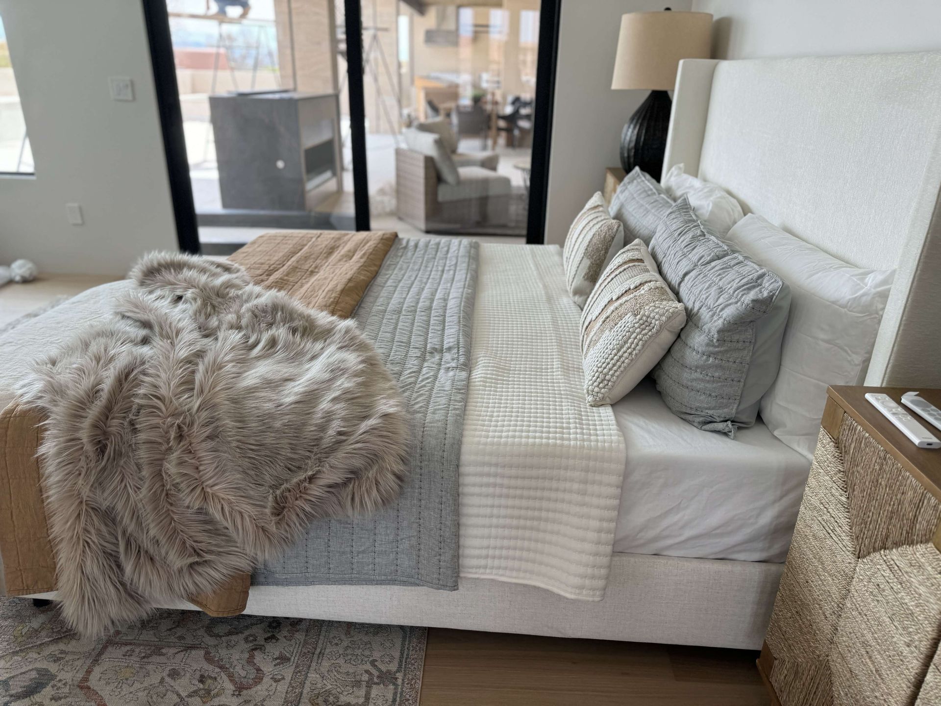 A bedroom with a large bed and a sliding glass door