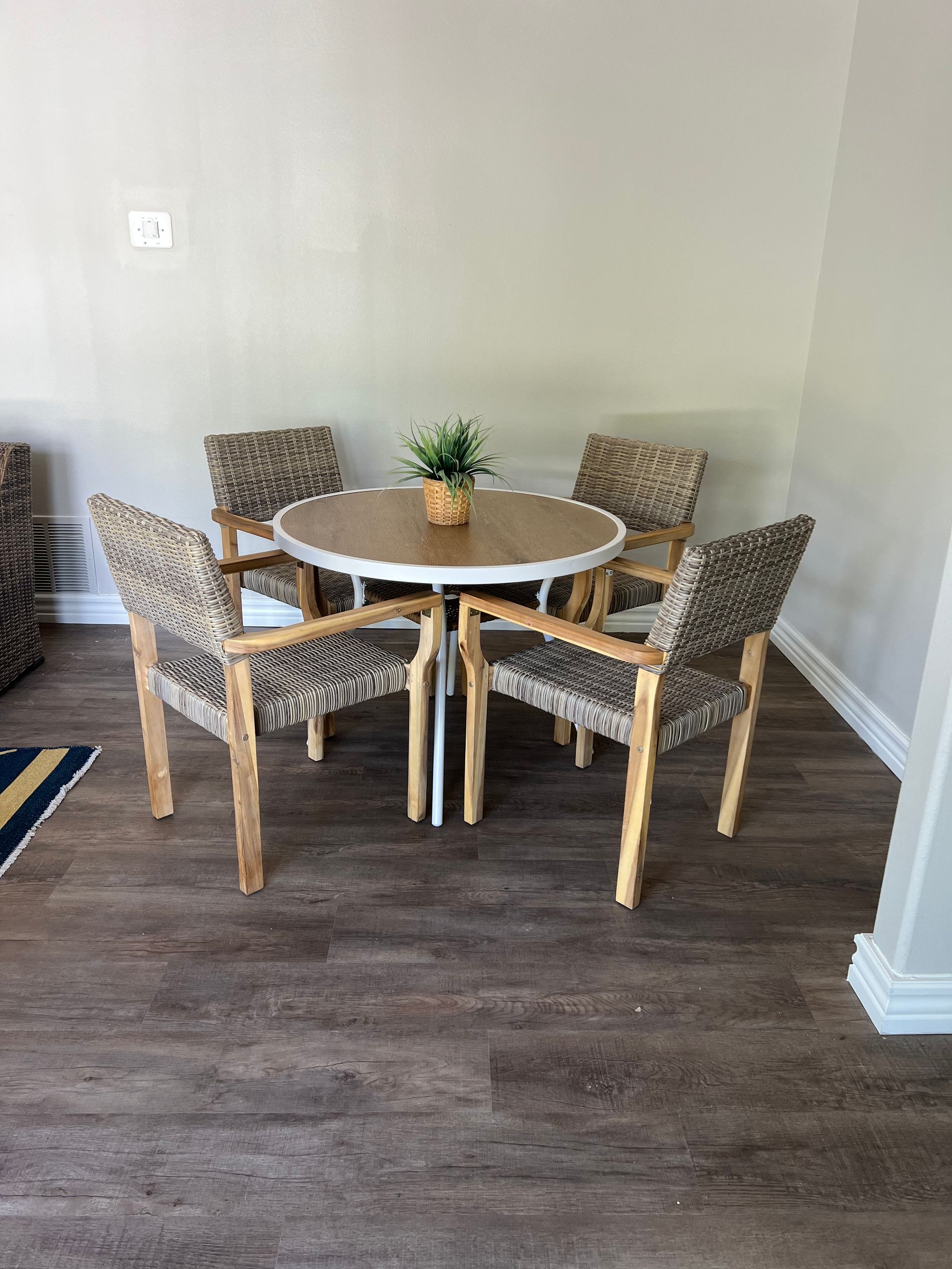 There is a table and chairs in the room.