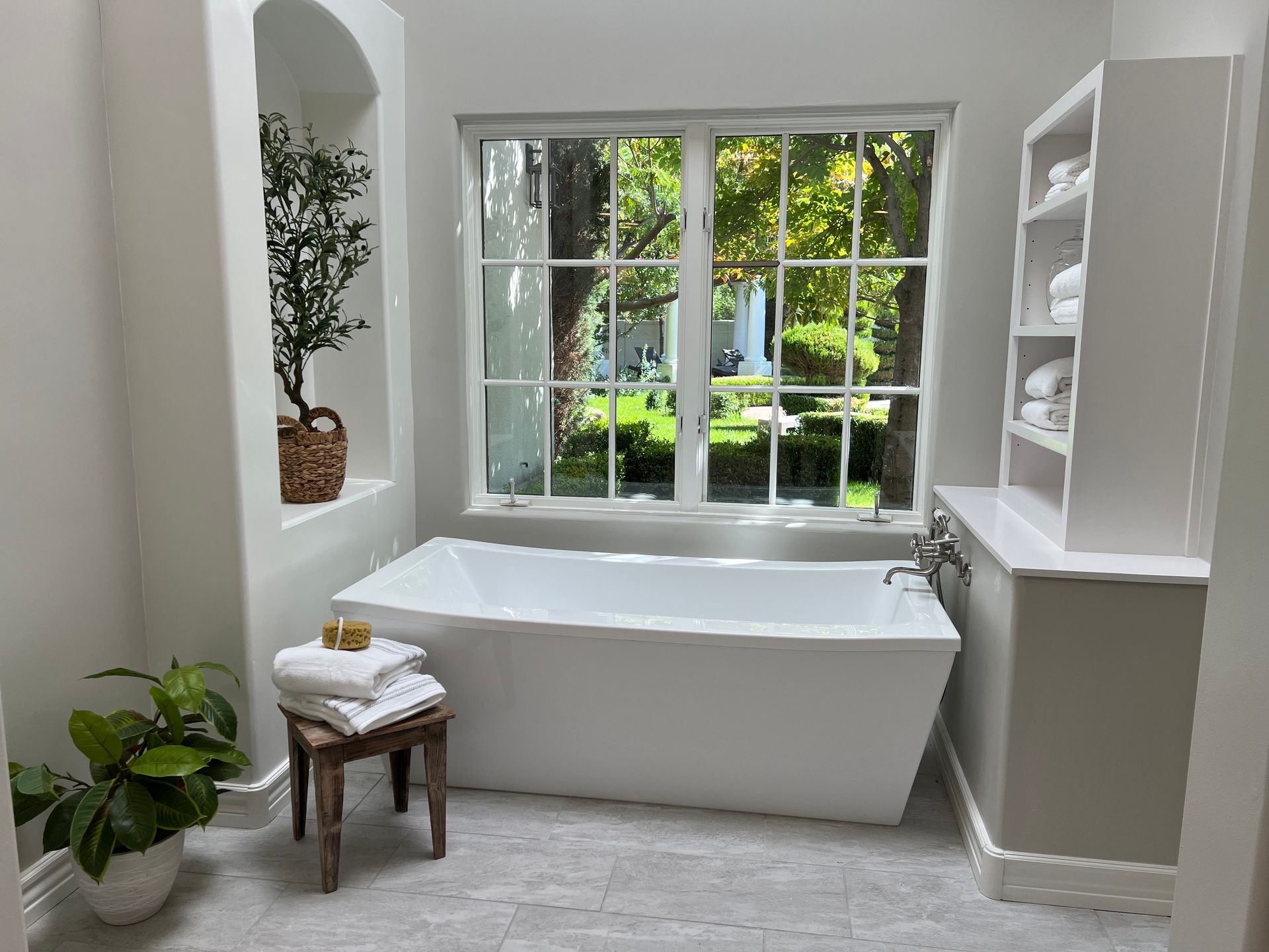 A bathroom with a large tub and a window.