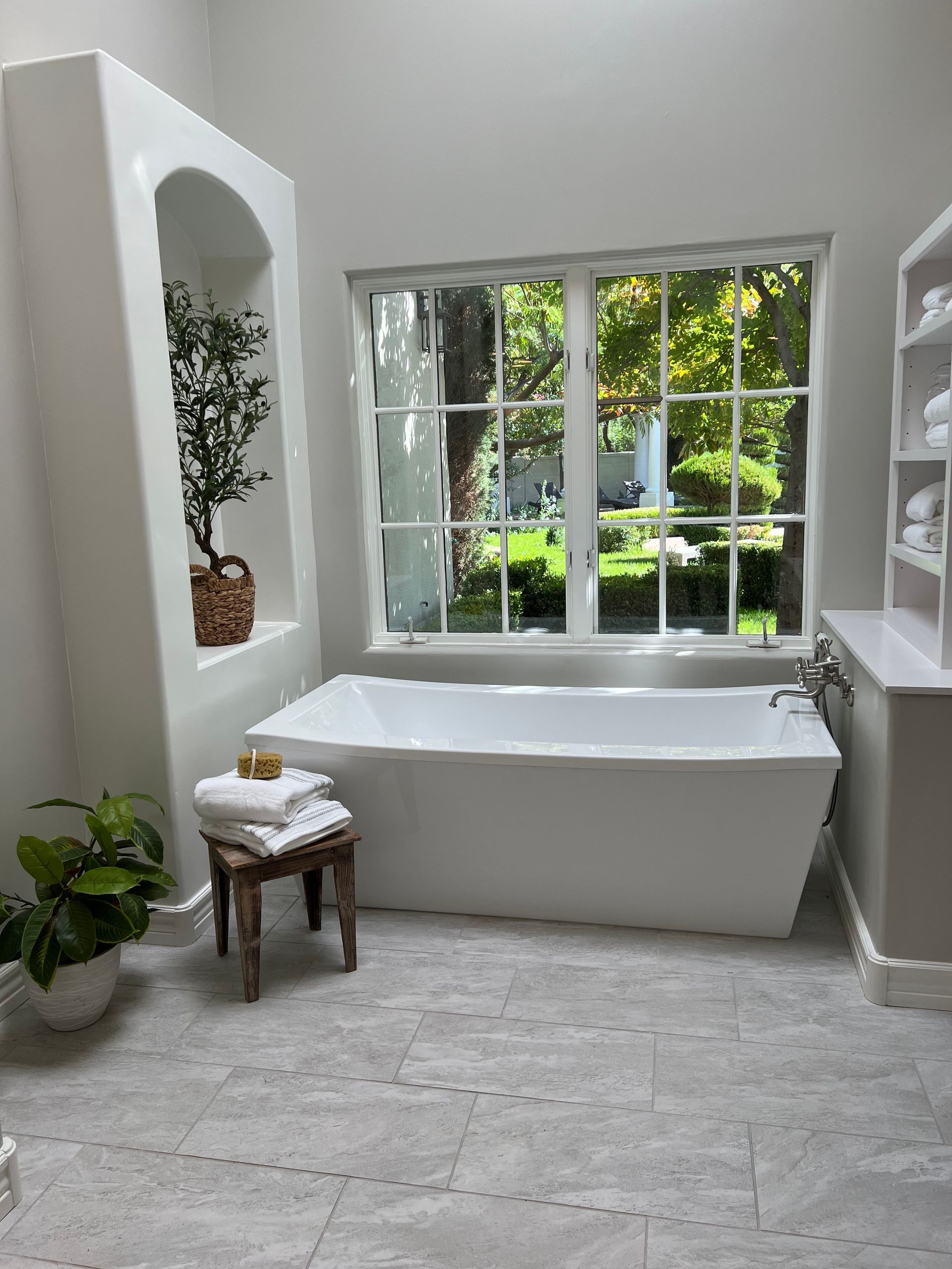A bathroom with a large tub and a window.