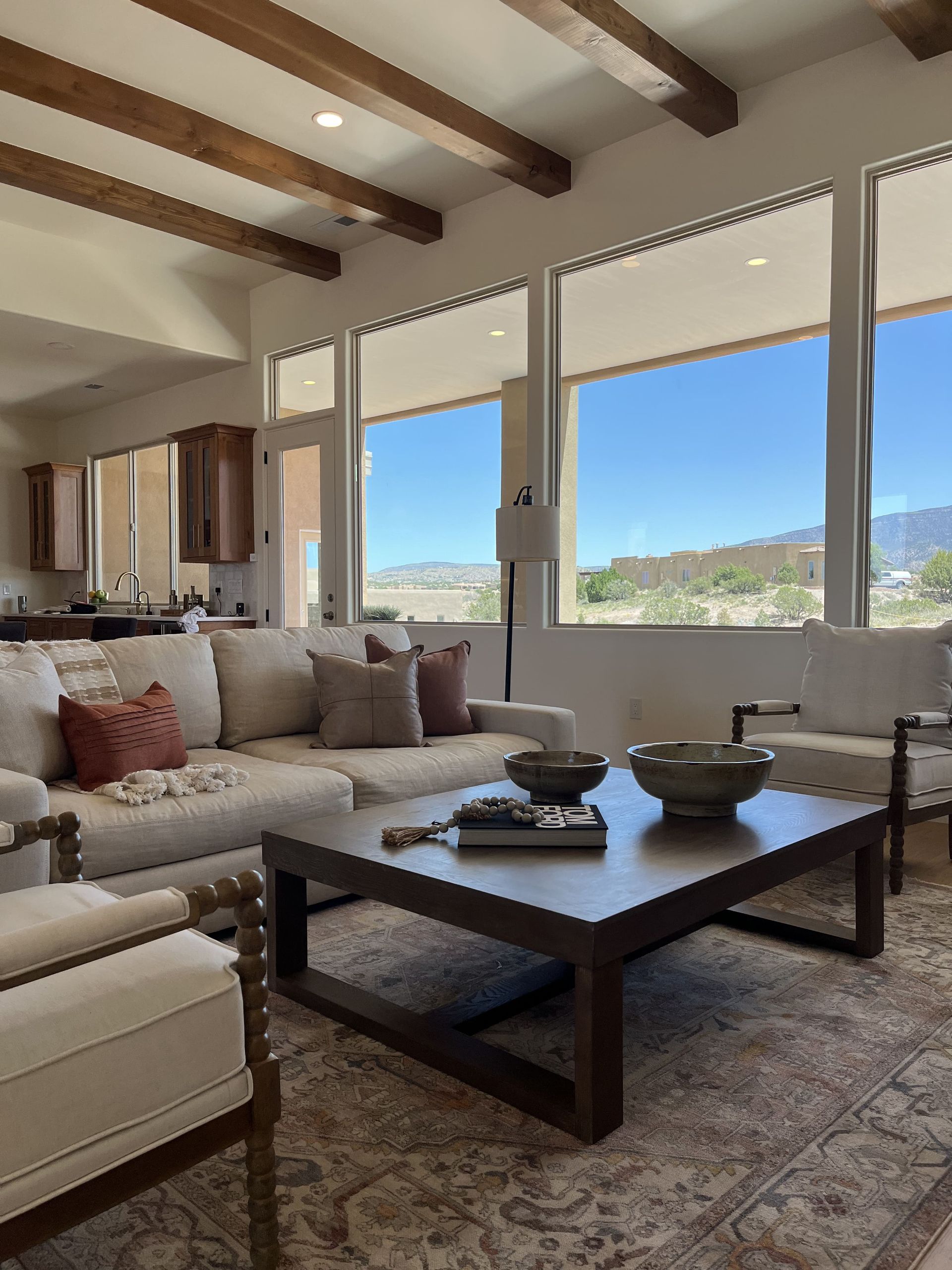 A living room with a couch , chairs and a coffee table.