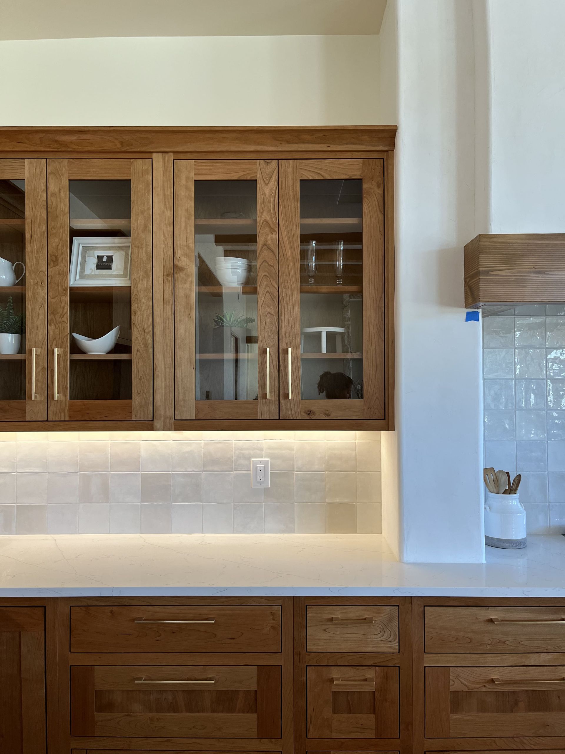A kitchen with wooden cabinets and a white counter top.