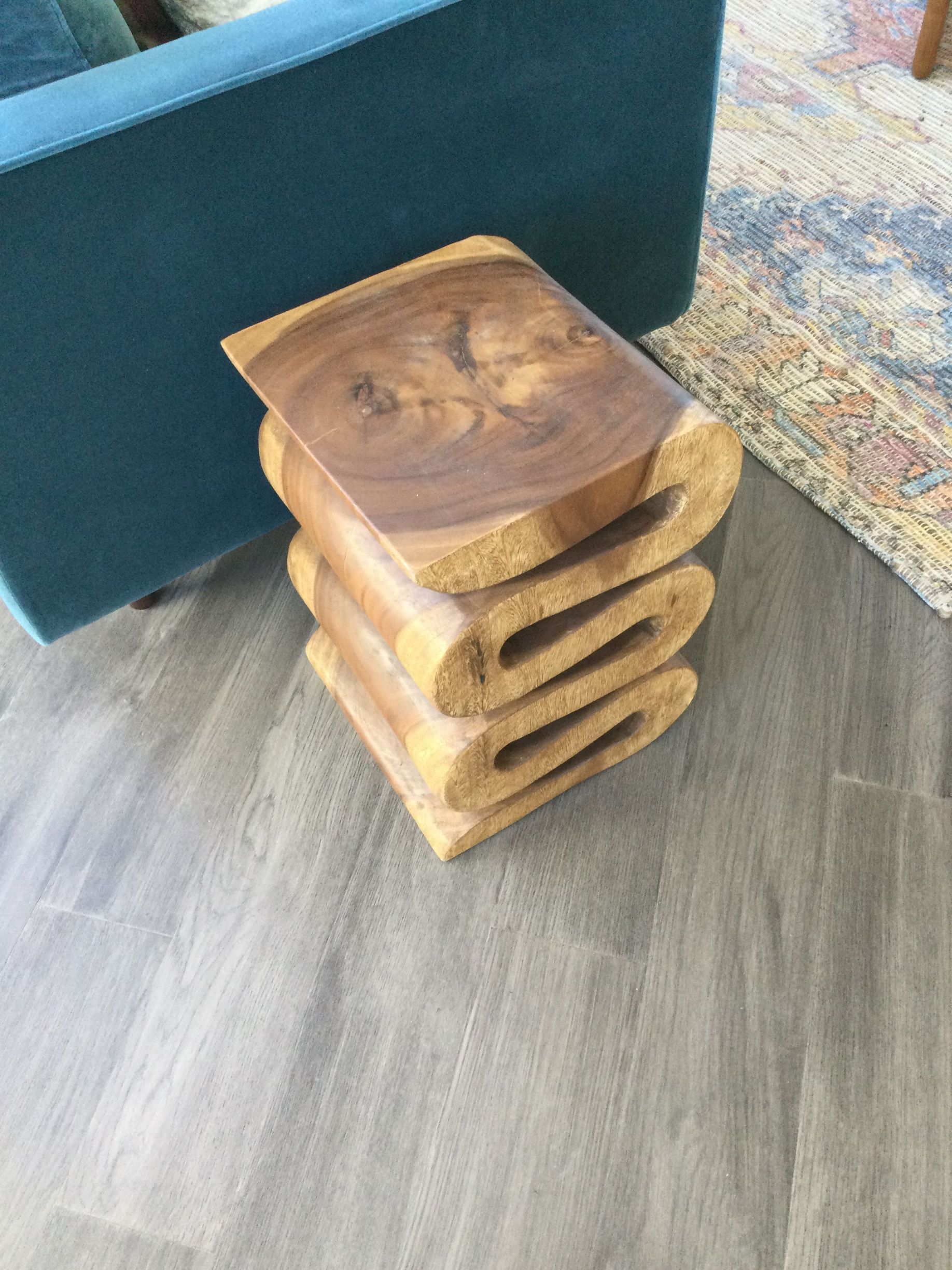 A wooden stool is stacked on top of each other in a living room.