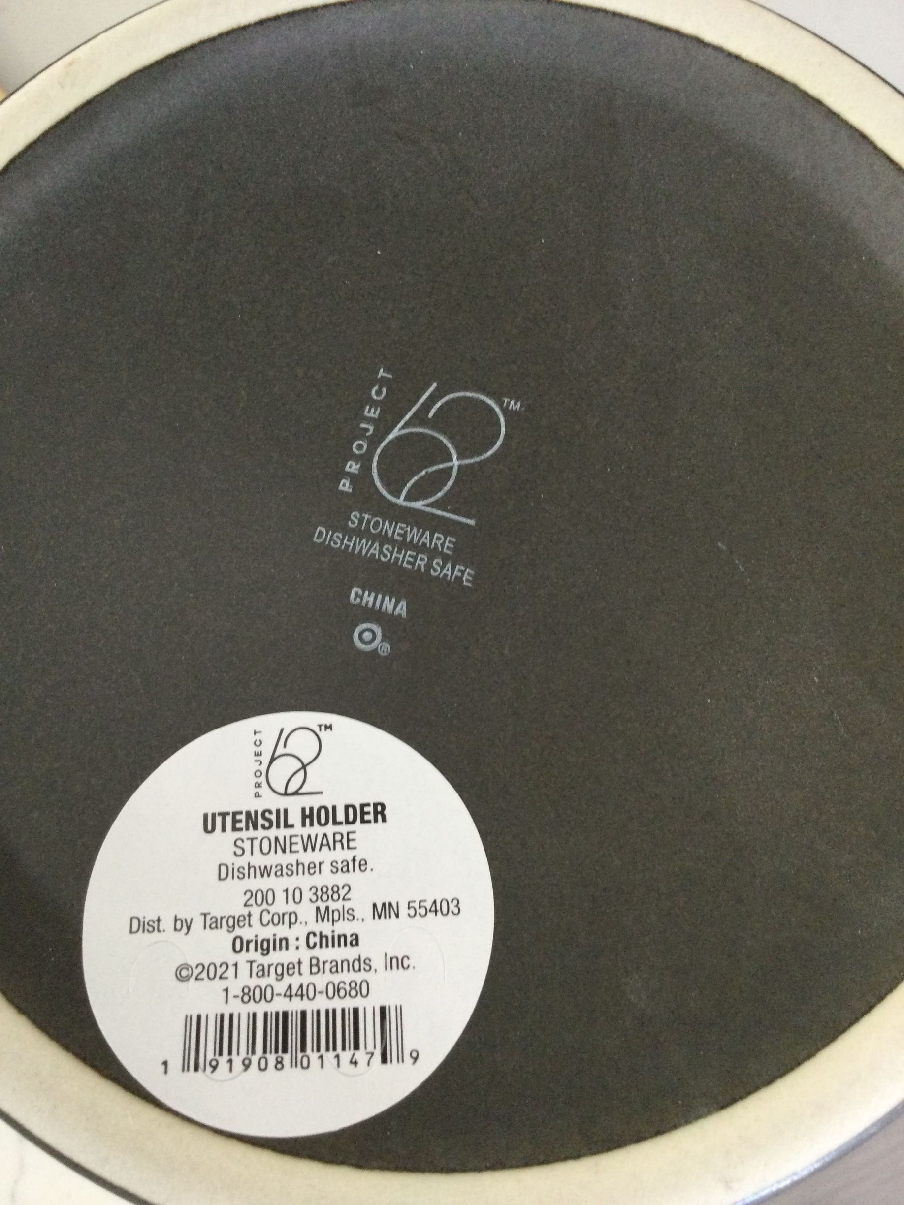 A black utensil holder with a white label on it