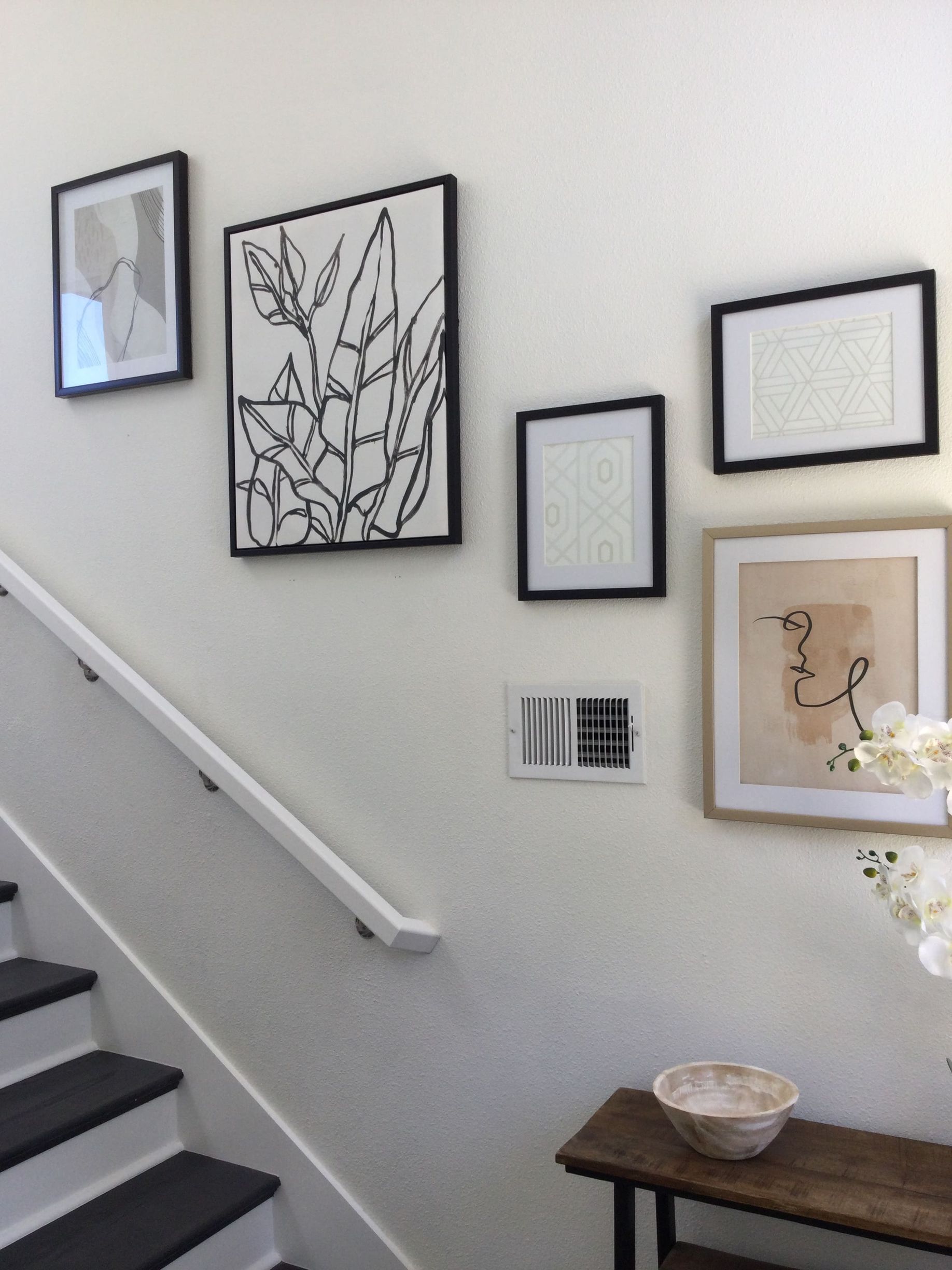 A staircase with a few pictures on the wall