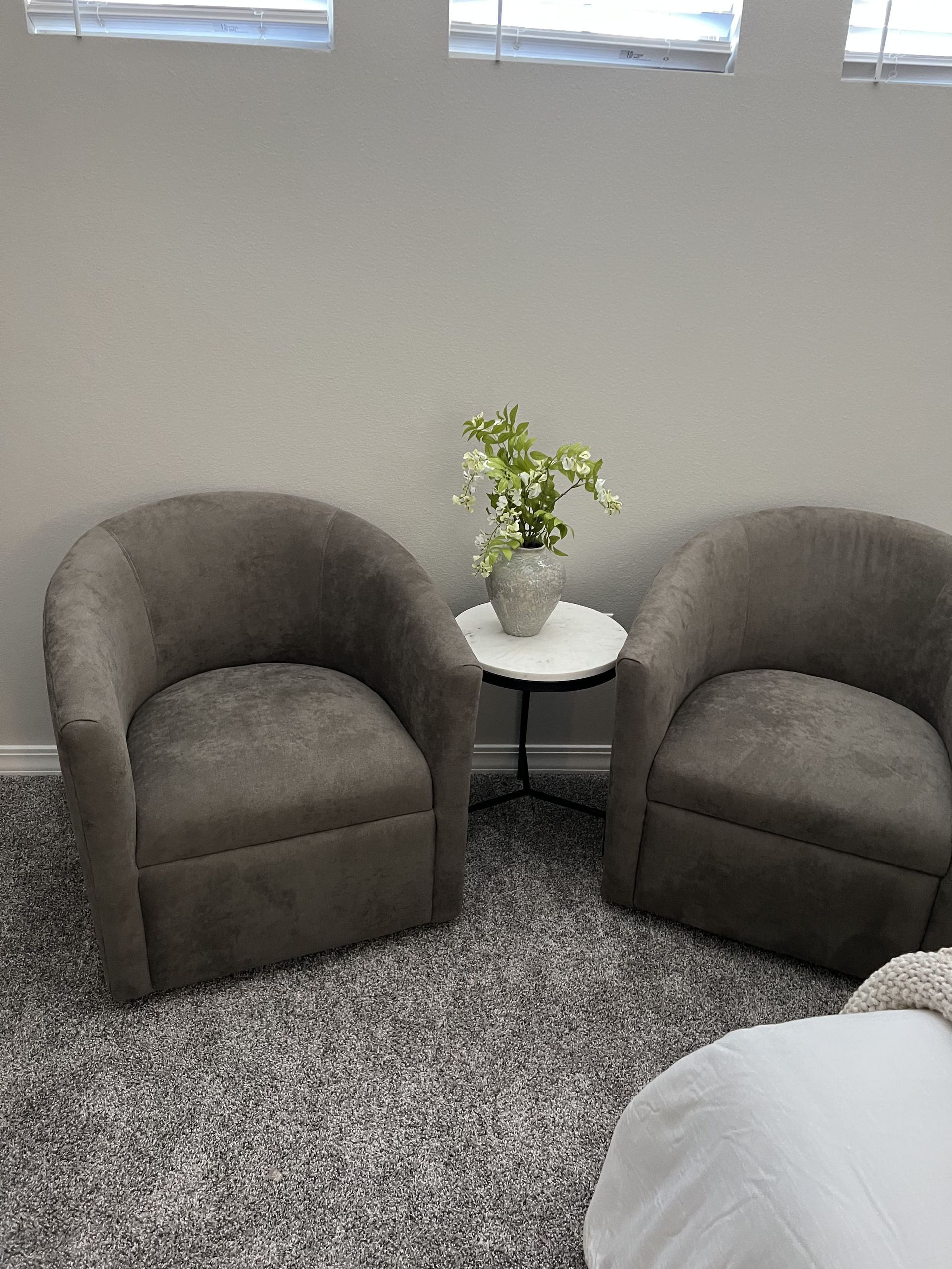There are two chairs and a table in the room.