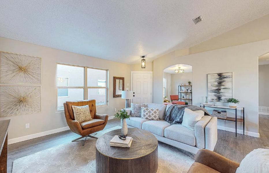 A living room with a couch , chair , and coffee table.
