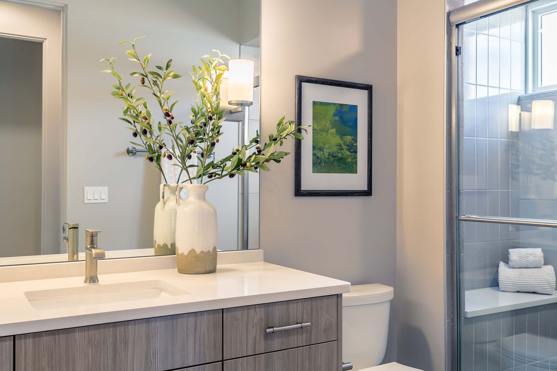 A bathroom with a sink , toilet , and shower.