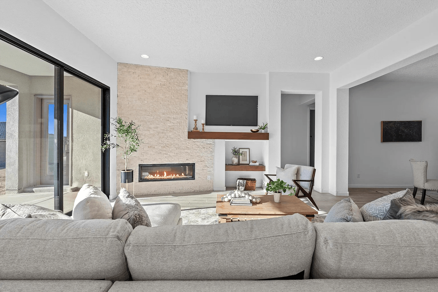 A living room with a couch , fireplace and television.