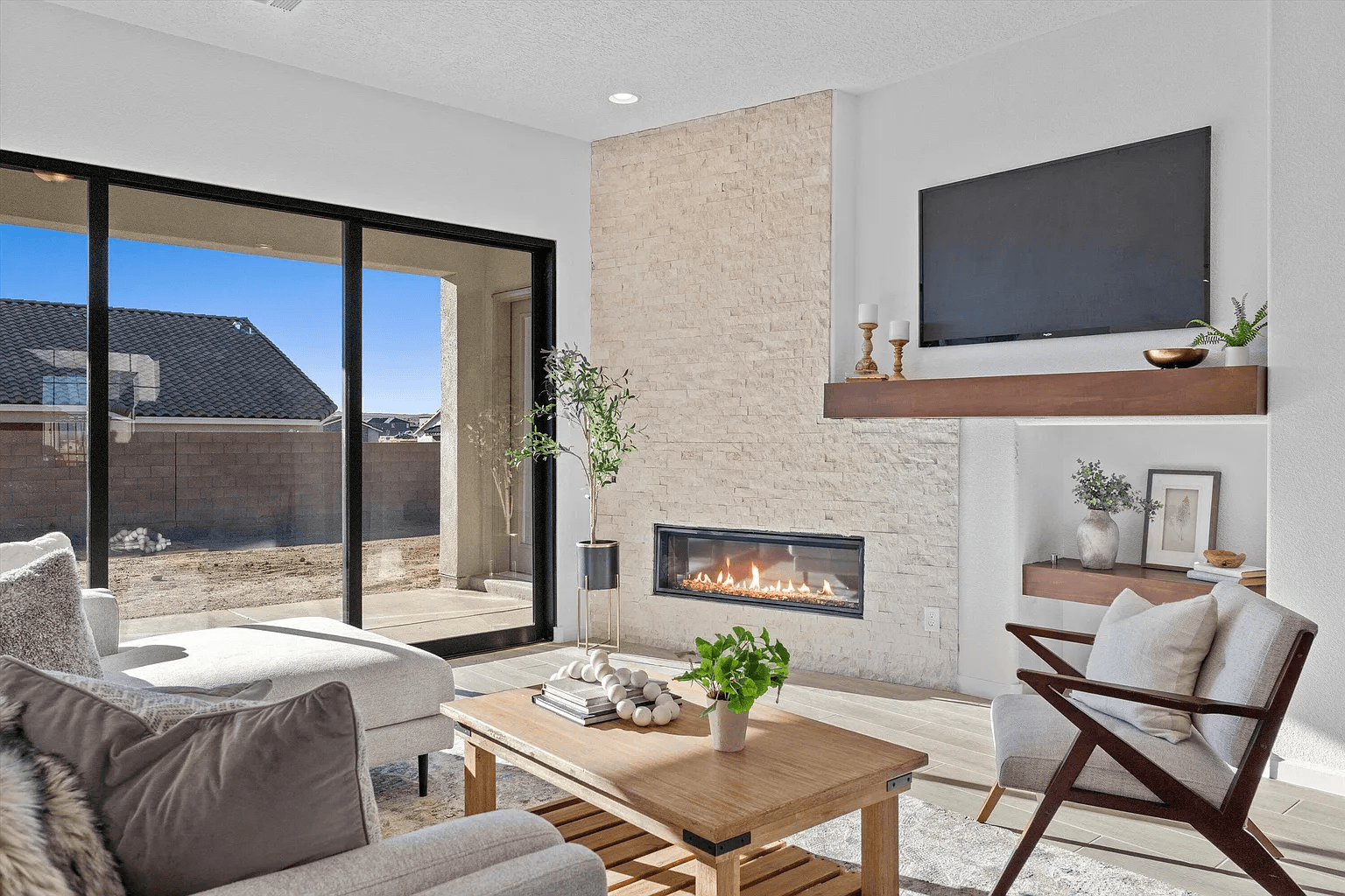 A living room with a fireplace and a flat screen tv.