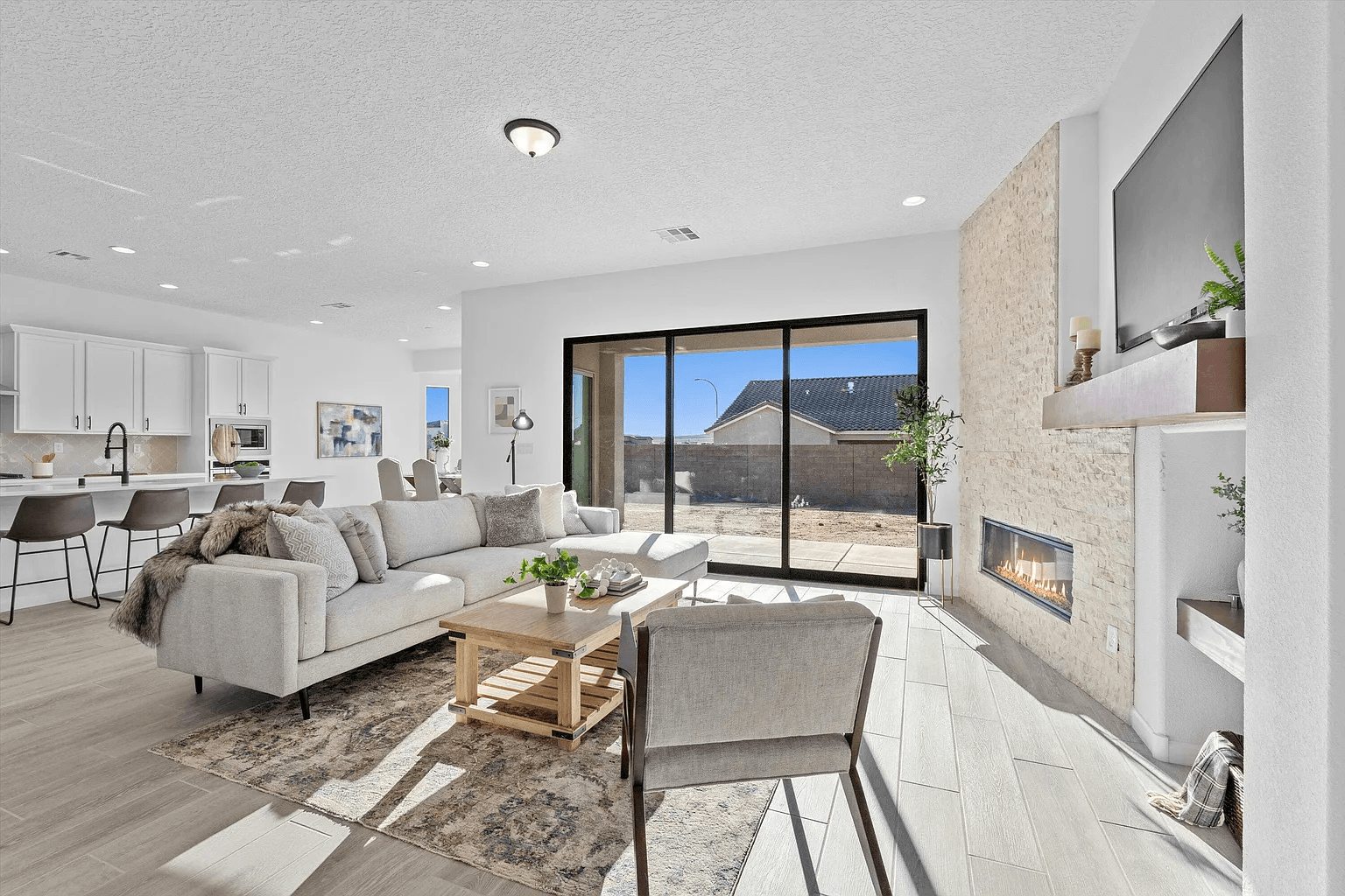A living room with a couch , chairs , coffee table and fireplace.
