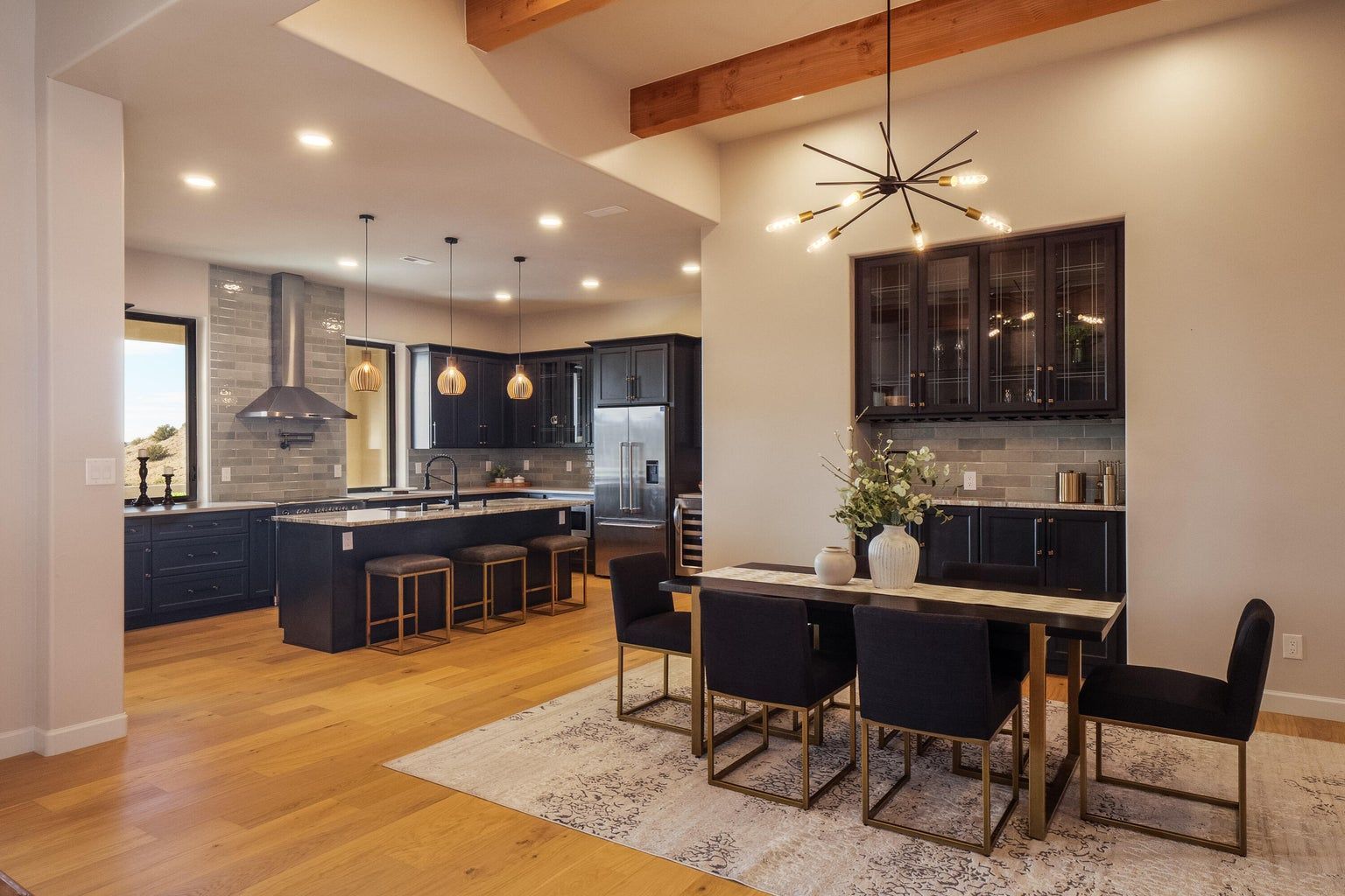 A kitchen and dining room in a house with a table and chairs.