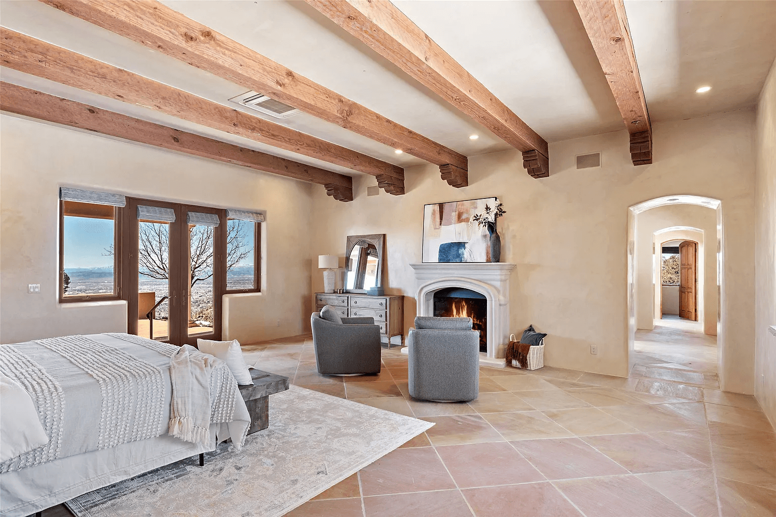 A living room with a couch , chairs , and a fireplace.
