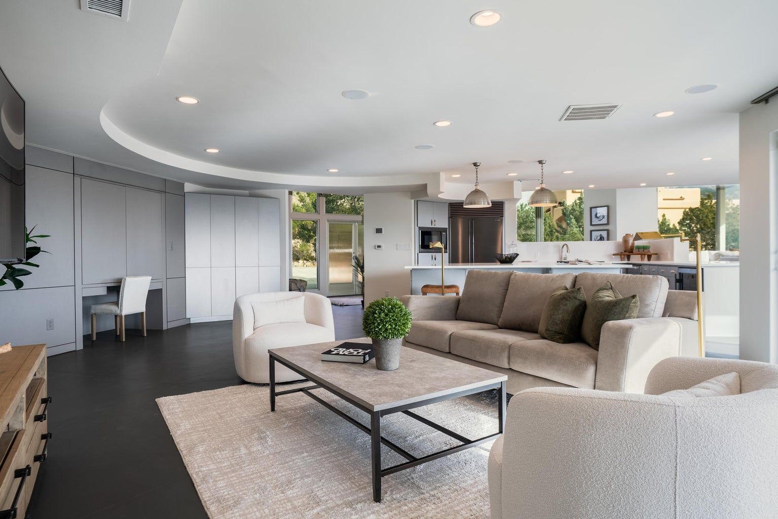 A living room with a couch , chairs , and a coffee table.
