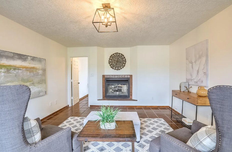 A living room with two chairs and a fireplace.