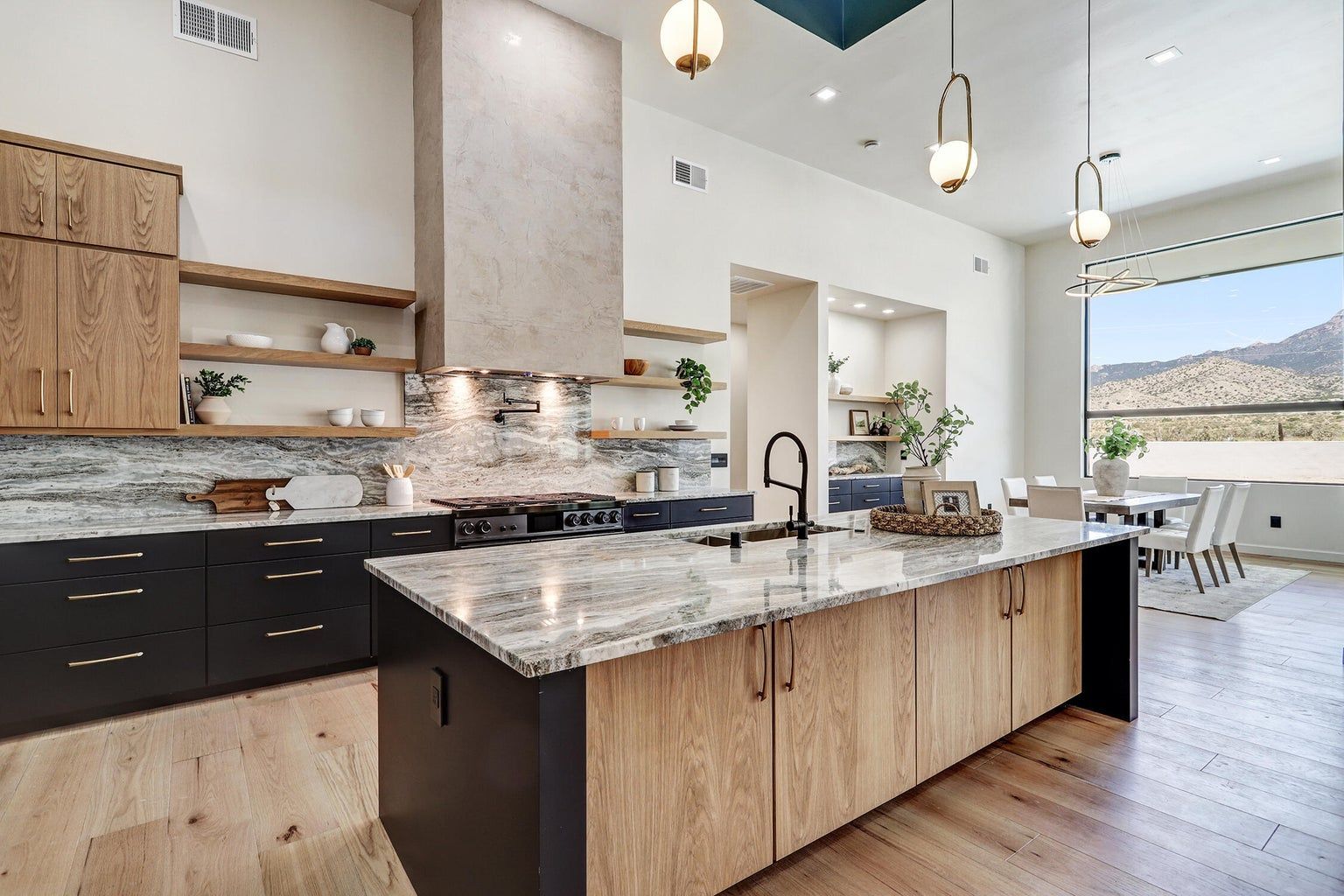 A kitchen with a large island and granite counter tops.