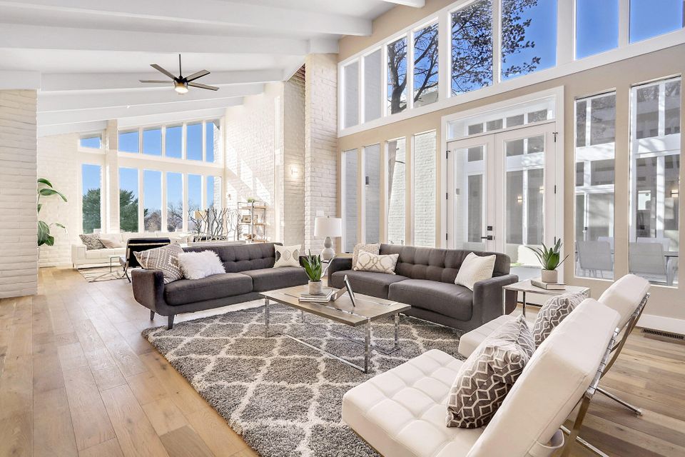 A living room filled with furniture and a ceiling fan.