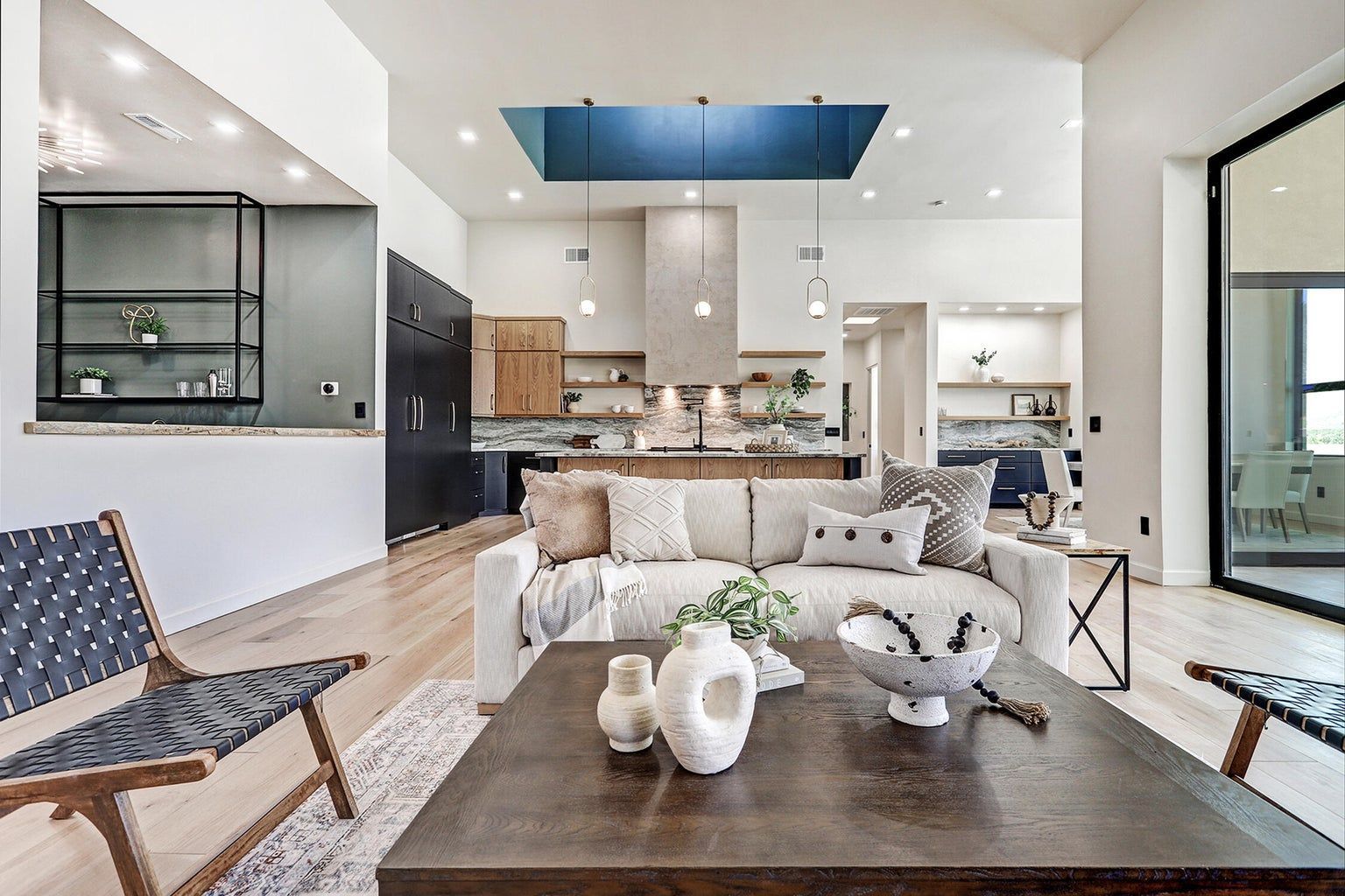 A living room with a couch , chairs , and a coffee table.