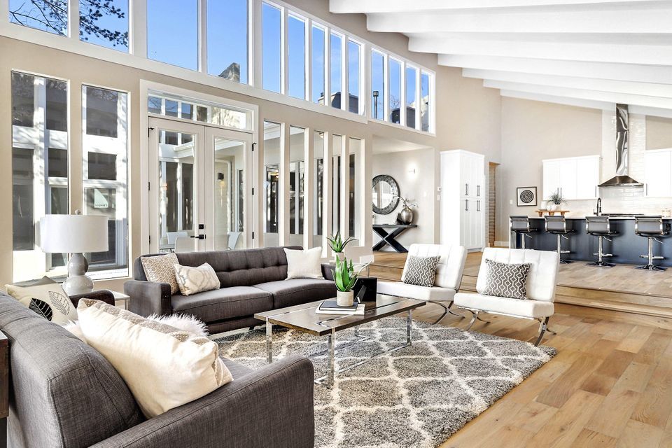 A living room filled with furniture and a lot of windows.