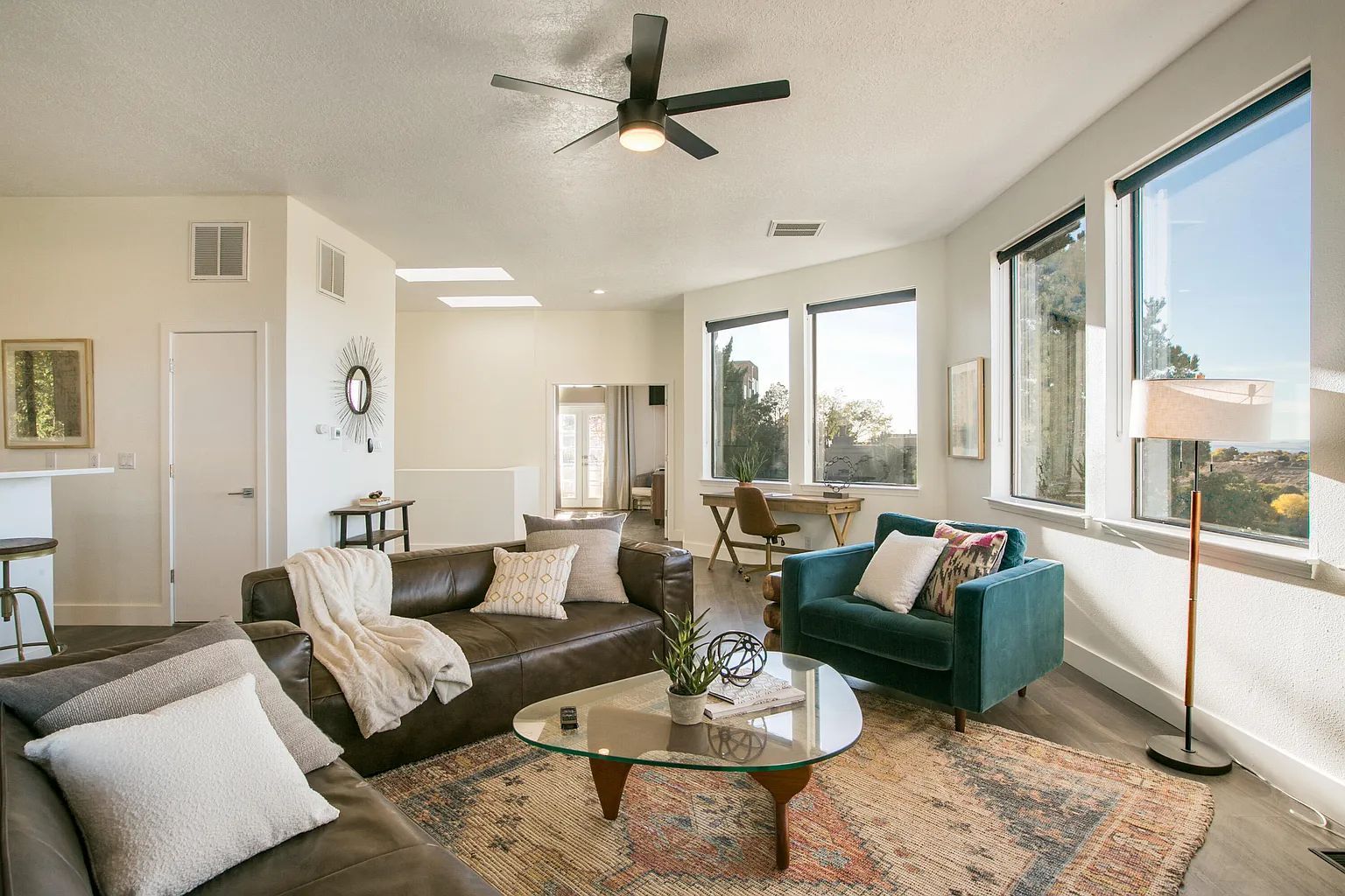 A living room filled with furniture and a ceiling fan