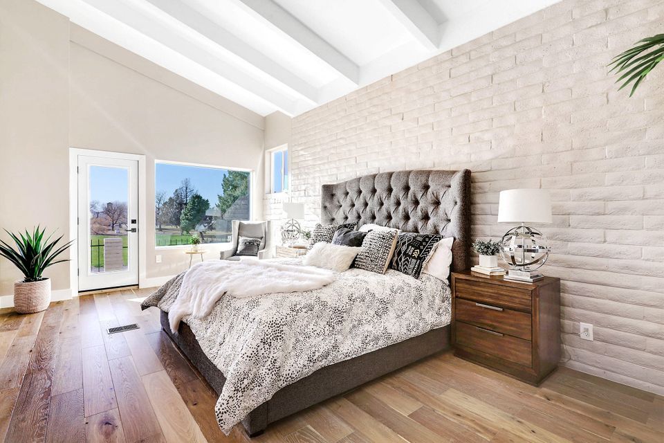 A bedroom with a bed , nightstand , and window.