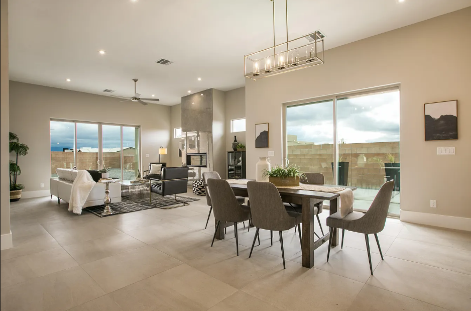 There is a dining table and chairs in the middle of the room.