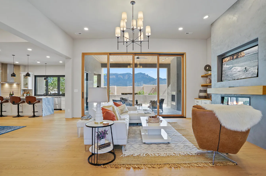 A living room with a couch , chair , table and television.