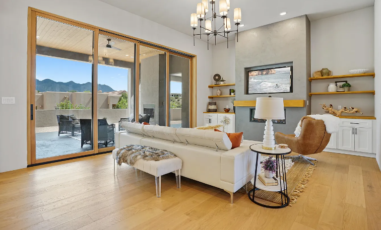 A living room with a couch , chair , table and television.