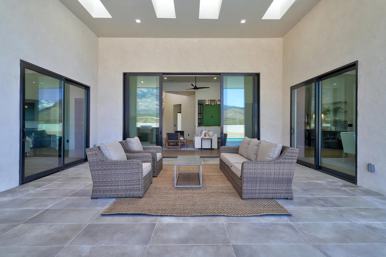 A patio with a couch , chairs , and a table.