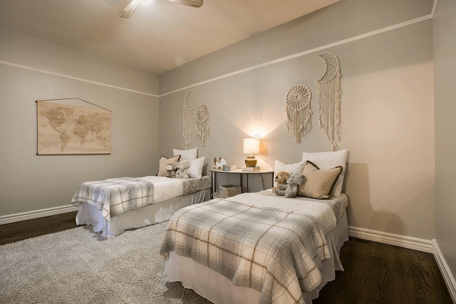 A bedroom with two twin beds and a ceiling fan.