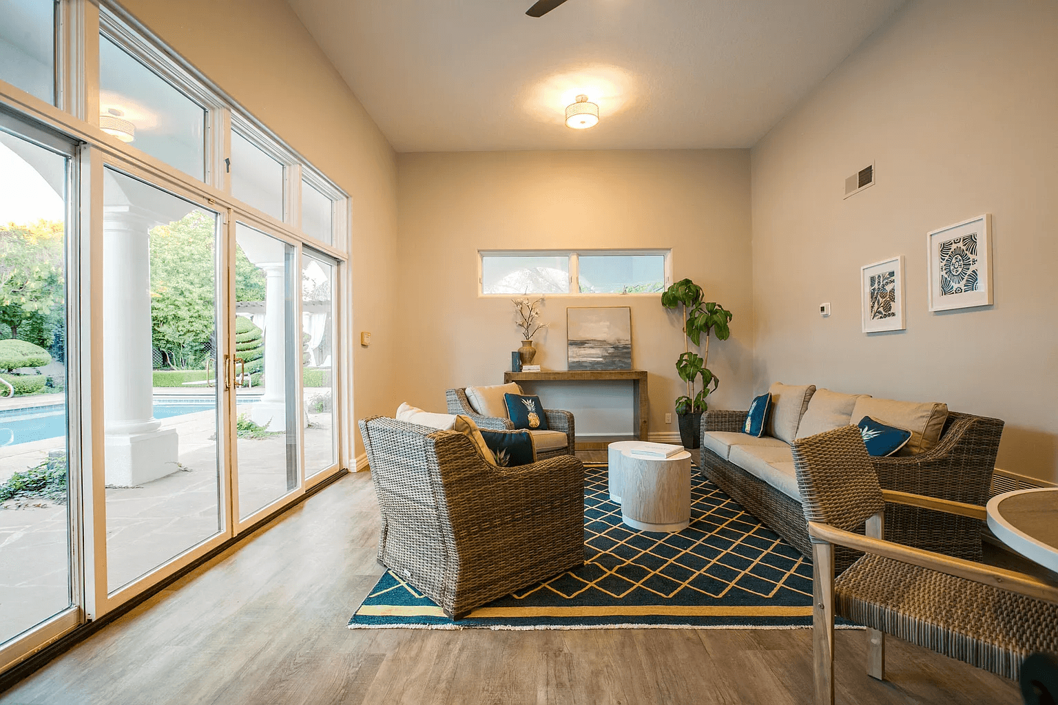 A living room with a couch , chairs , and a table.