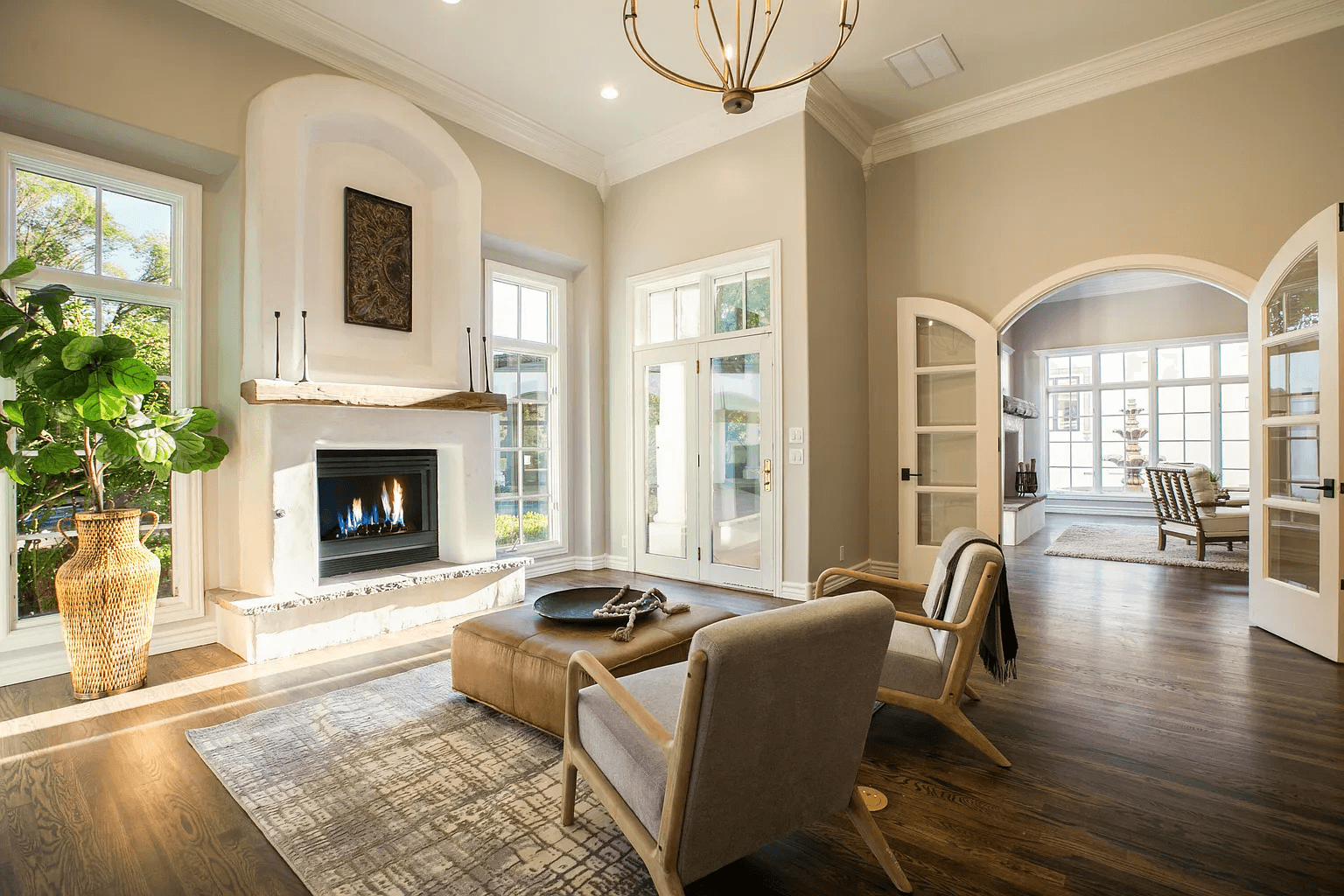 A living room with a fireplace , chairs , and a coffee table.