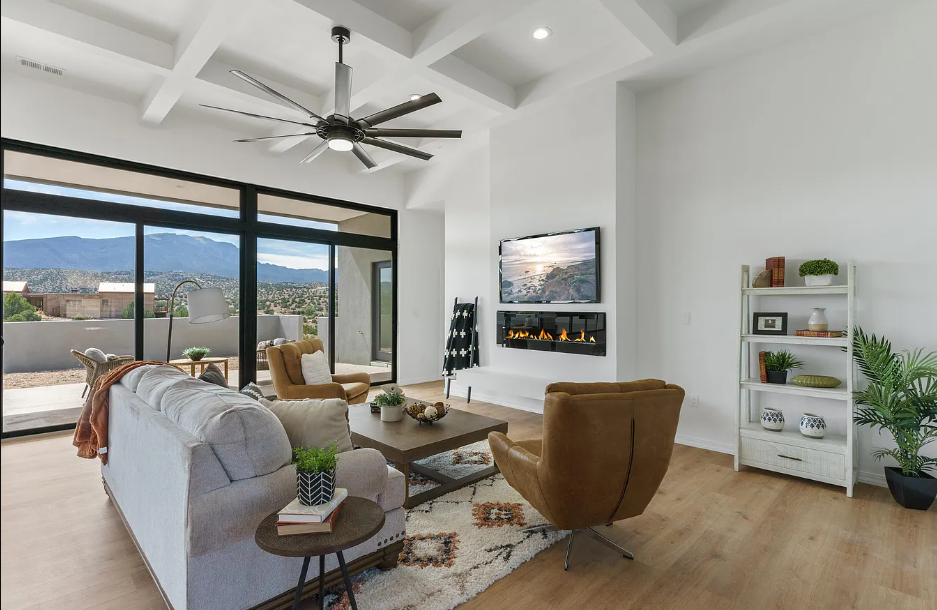 A living room with a couch , chairs , table and television.